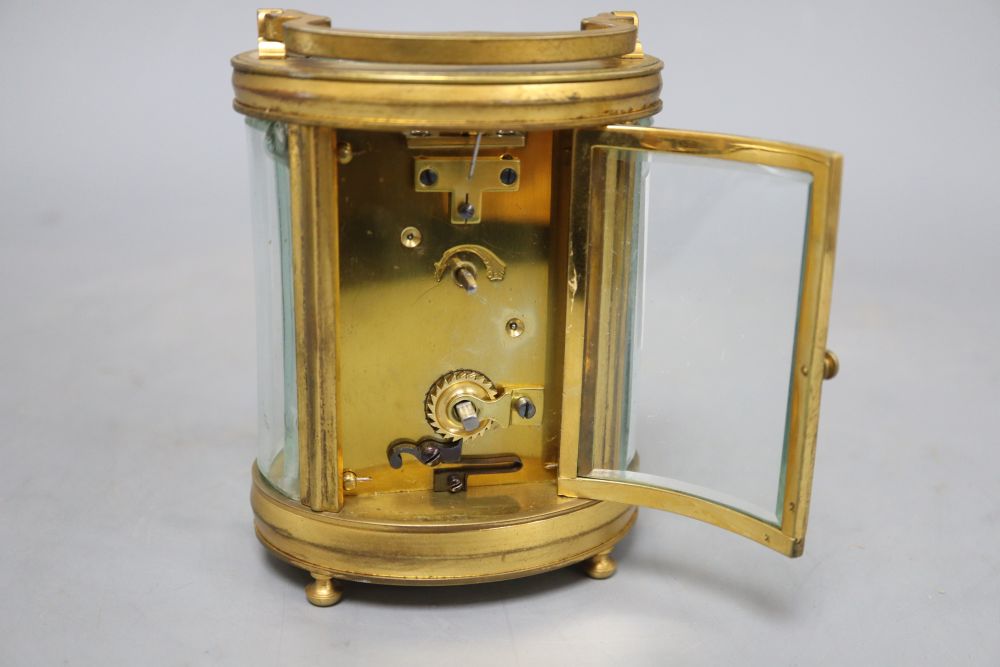 An oval brass carriage clock, height 12cm (handle down)